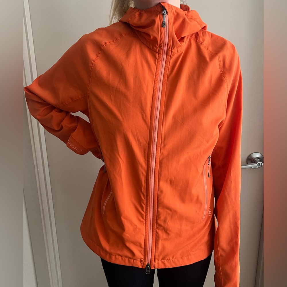Women’s orange Houdini rain jacket